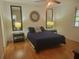 Bedroom with hardwood floors, mirrors, ceiling fan and decorative lamps at 4148 Silver Hill Ct, Snellville, GA 30039