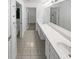Bathroom with dual sinks and a large mirror, creating an open and bright space at 3824 Vineyards Lake Nw Cir # U16, Kennesaw, GA 30144