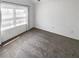 Inviting bedroom featuring large window, neutral carpet, and ample natural light at 3824 Vineyards Lake Nw Cir # U16, Kennesaw, GA 30144