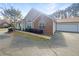 Home featuring a two-car garage, brick accents, well-maintained landscaping, and an inviting curb appeal at 3824 Vineyards Lake Nw Cir # U16, Kennesaw, GA 30144