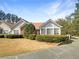 Charming home featuring a well-manicured lawn, beautiful shrubs, and a symmetrical design with a mix of siding and brick accents at 3824 Vineyards Lake Nw Cir # U16, Kennesaw, GA 30144