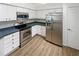 Modern kitchen featuring stainless steel appliances and white cabinets at 3824 Vineyards Lake Nw Cir # U16, Kennesaw, GA 30144