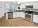 Modern kitchen with stainless steel appliances, wood floors, and ample counter space at 3824 Vineyards Lake Nw Cir # U16, Kennesaw, GA 30144
