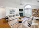 Bright, staged living room with vaulted ceilings, large window, fireplace, modern furnishings, and neutral color palette at 3824 Vineyards Lake Nw Cir # U16, Kennesaw, GA 30144