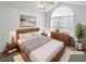Staged main bedroom with vaulted ceilings, large window, neutral decor, and modern furnishings at 3824 Vineyards Lake Nw Cir # U16, Kennesaw, GA 30144