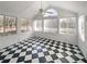 Bright sunroom with large windows and a distinctive black and white checkered floor at 3824 Vineyards Lake Nw Cir # U16, Kennesaw, GA 30144