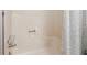 White tub shower featuring clear glass handles with a floral shower curtain at 2341 Cedar Dr, Lawrenceville, GA 30043