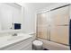 Simple bathroom with a shower-tub combo, a vanity sink with a mirror, and a white toilet at 2341 Cedar Dr, Lawrenceville, GA 30043