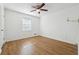 Minimalist bedroom featuring light-colored walls, wood-look floors, and a ceiling fan with light at 2341 Cedar Dr, Lawrenceville, GA 30043