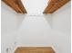 Walk-in closet featuring hardwood floors and an open storage system with wooden supports at 2341 Cedar Dr, Lawrenceville, GA 30043