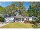 Charming single-story home featuring a welcoming front porch and an attached two-car garage at 2341 Cedar Dr, Lawrenceville, GA 30043
