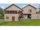 Back exterior of home with a large yard, screened-in porch, and a lower-level entrance at 3730 Willow Mill Dr, Lawrenceville, GA 30044