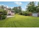 Expansive backyard with lush green lawn, mature trees, and a storage shed at 3730 Willow Mill Dr, Lawrenceville, GA 30044
