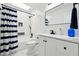 Modern bathroom with sleek fixtures, white subway tile, a shower, and black accents at 3730 Willow Mill Dr, Lawrenceville, GA 30044