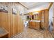 Rustic bathroom with wood paneling, double vanity, toilet, and washer/dryer at 3730 Willow Mill Dr, Lawrenceville, GA 30044
