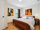 Cozy bedroom with a wooden bed frame, parquet floors, and natural light from the window at 3730 Willow Mill Dr, Lawrenceville, GA 30044