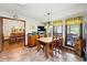 Bright dining room featuring a wood table, large windows with bright curtains, and tile floors at 3730 Willow Mill Dr, Lawrenceville, GA 30044