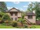 Beautiful home featuring a wood exterior, well-kept lawn, and flourishing landscaping at 3730 Willow Mill Dr, Lawrenceville, GA 30044