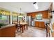Warm kitchen with tile floors, stainless steel appliances, wood cabinets, and dining area at 3730 Willow Mill Dr, Lawrenceville, GA 30044