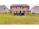Large, grassy backyard with patio and outdoor furniture at 6990 Annie Walk, Lithonia, GA 30038