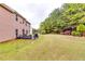 Expansive backyard features a patio with outdoor seating and lush landscaping at 6990 Annie Walk, Lithonia, GA 30038