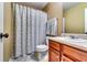 Cozy bathroom with decorative shower curtain, vanity, and a traditional toilet at 6990 Annie Walk, Lithonia, GA 30038