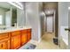 Bathroom with double sinks, wood cabinets, and a built-in bathtub at 6990 Annie Walk, Lithonia, GA 30038