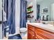 A stylish bathroom featuring a vanity, wooden shelves, and coordinated decor at 6990 Annie Walk, Lithonia, GA 30038