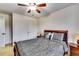 Bedroom with natural lighting featuring a queen bed and a matching bedside table with a lamp at 6990 Annie Walk, Lithonia, GA 30038