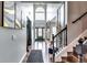 Stunning foyer with hardwood floors, large windows, and staircase leading to a second floor at 6990 Annie Walk, Lithonia, GA 30038