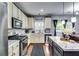A bright open kitchen offers stainless steel appliances and a center island with marble countertops at 6990 Annie Walk, Lithonia, GA 30038