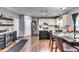 An open kitchen features a mini-bar, an island, and a connected dining area with seating for six at 6990 Annie Walk, Lithonia, GA 30038