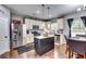 This open kitchen features stainless steel appliances and a center island with marble countertops at 6990 Annie Walk, Lithonia, GA 30038