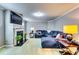 Cozy living room featuring a fireplace, tv, and an oversized blue sectional couch at 6990 Annie Walk, Lithonia, GA 30038