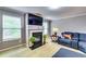 Comfortable living room featuring a fireplace, TV, and stylish furniture at 6990 Annie Walk, Lithonia, GA 30038