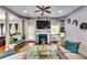 Spacious living room with a decorative fireplace, plush seating, and lots of natural light at 6990 Annie Walk, Lithonia, GA 30038