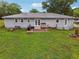 Expansive backyard with a patio, fire pit, and ample space for outdoor activities at 815 Tanner Rd, Dacula, GA 30019