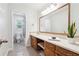 Bathroom featuring granite floors, wood cabinets, and a large mirror at 815 Tanner Rd, Dacula, GA 30019