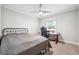 Simple bedroom with carpeted floors, a ceiling fan, and a desk for study or work at 815 Tanner Rd, Dacula, GA 30019
