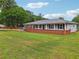 Exterior shot of a lovely single-story home, complete with a well-manicured lawn at 815 Tanner Rd, Dacula, GA 30019