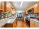 Well-lit kitchen features wooden cabinets, stainless steel appliances, granite countertops, and mosaic tile backsplash at 815 Tanner Rd, Dacula, GA 30019