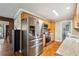 Open kitchen design with stainless steel appliances and wood cabinetry at 815 Tanner Rd, Dacula, GA 30019