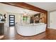Open living room boasts hardwood floors, stone fireplace, ceiling fan and modern decor at 815 Tanner Rd, Dacula, GA 30019
