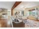 Cozy living room with a large sectional couch and beautiful hardwood floors at 815 Tanner Rd, Dacula, GA 30019