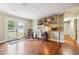Bright living room with hardwood floors, a built-in bookshelf, and glass doors leading to the yard at 815 Tanner Rd, Dacula, GA 30019