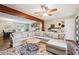 Bright and spacious living room with a sectional couch, wood floors, and stylish decor at 815 Tanner Rd, Dacula, GA 30019