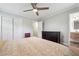 Bright bedroom with a ceiling fan, a dresser, an ensuite bathroom, and closets at 815 Tanner Rd, Dacula, GA 30019