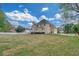 Expansive backyard featuring a large lawn and a two-story home with a deck at 1405 Wilmington Way, Grayson, GA 30017
