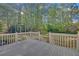 A raised deck looks out onto a large private backyard surrounded by mature trees at 1405 Wilmington Way, Grayson, GA 30017