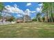 Large, level backyard with a well-maintained lawn and mature trees surrounding the perimeter at 1405 Wilmington Way, Grayson, GA 30017